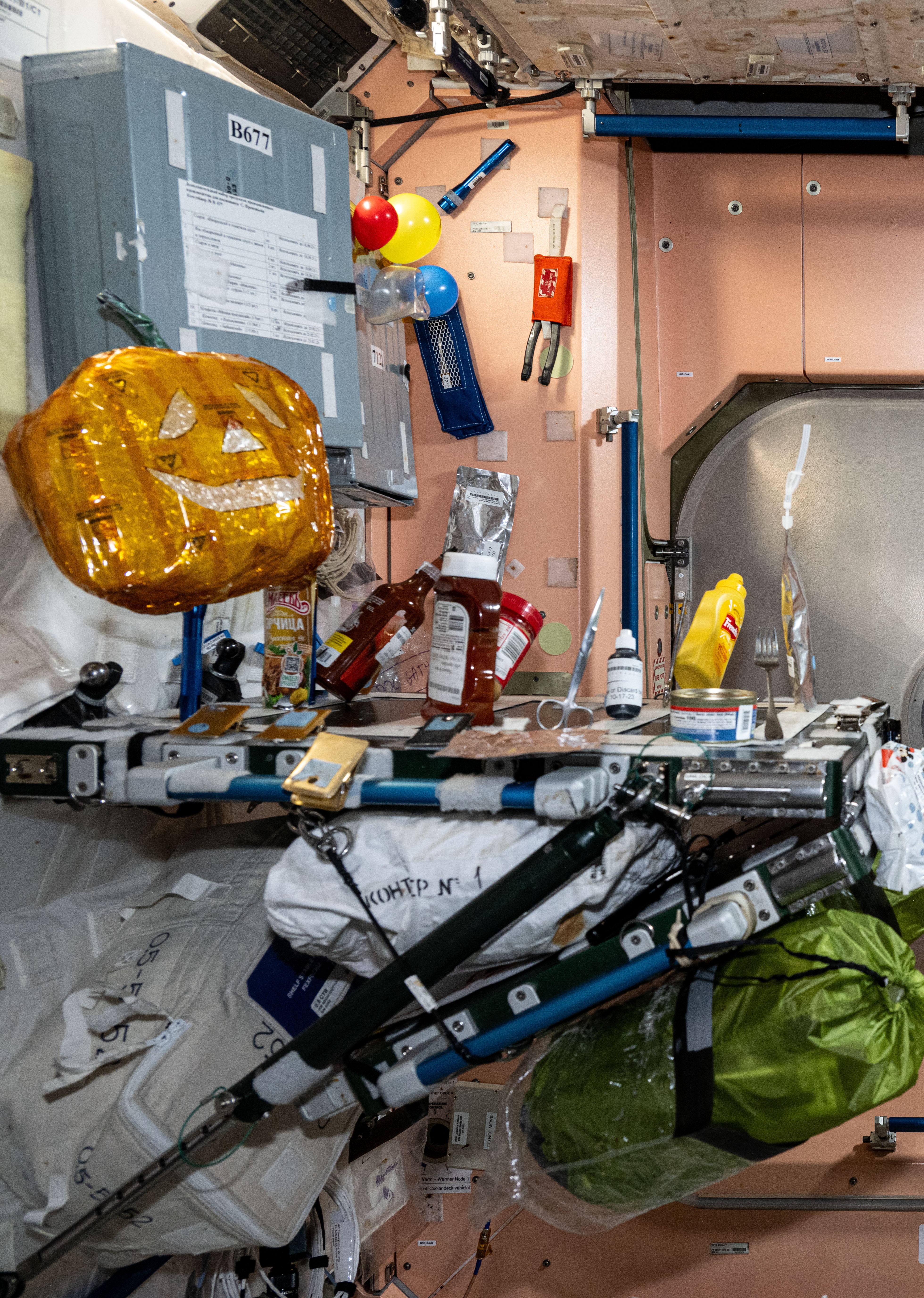 Expedition 72 crew decorated the Node 1 galley with a pumpkin in preparation for Halloween 2024