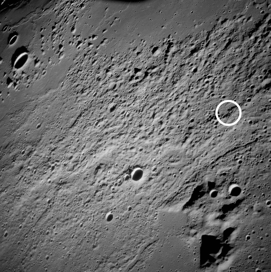 Image from lunar orbit of the Fra Mauro highlands, the proposed landing site for Apollo 13 (inside white circle)