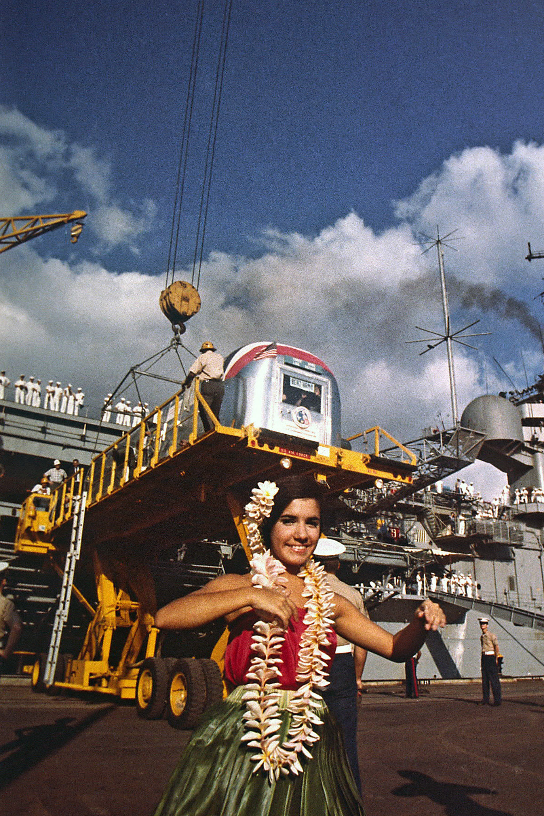 Workers at Pearl Harbor in Honolulu offload the Mobile Quarantine Facility (MQF) from Hornet with the Apollo 12 crew inside