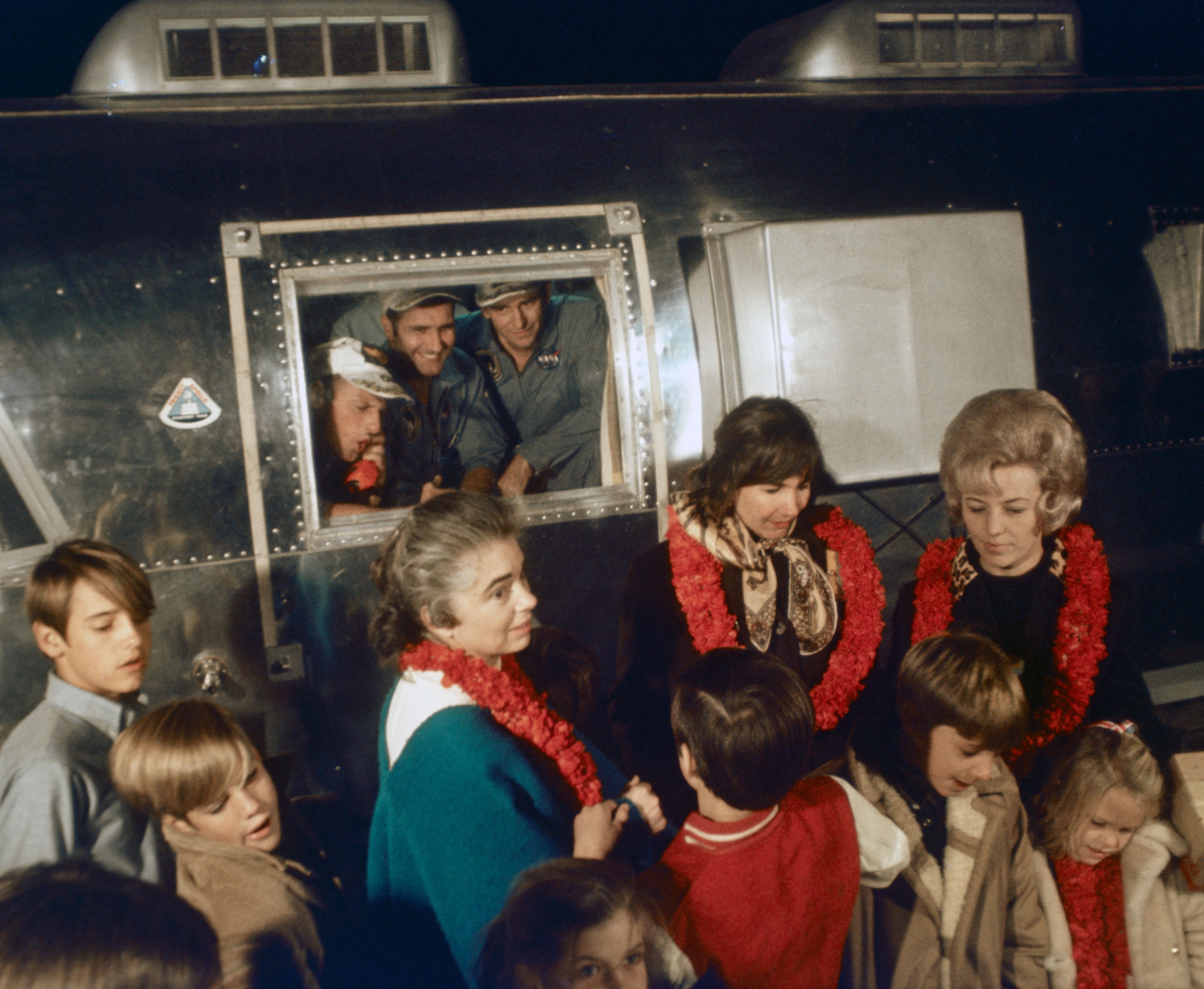 The Apollo 12 astronauts’ wives Barbara Gordon, left, Jane Conrad, and Sue Bean and their children welcome their husbands home