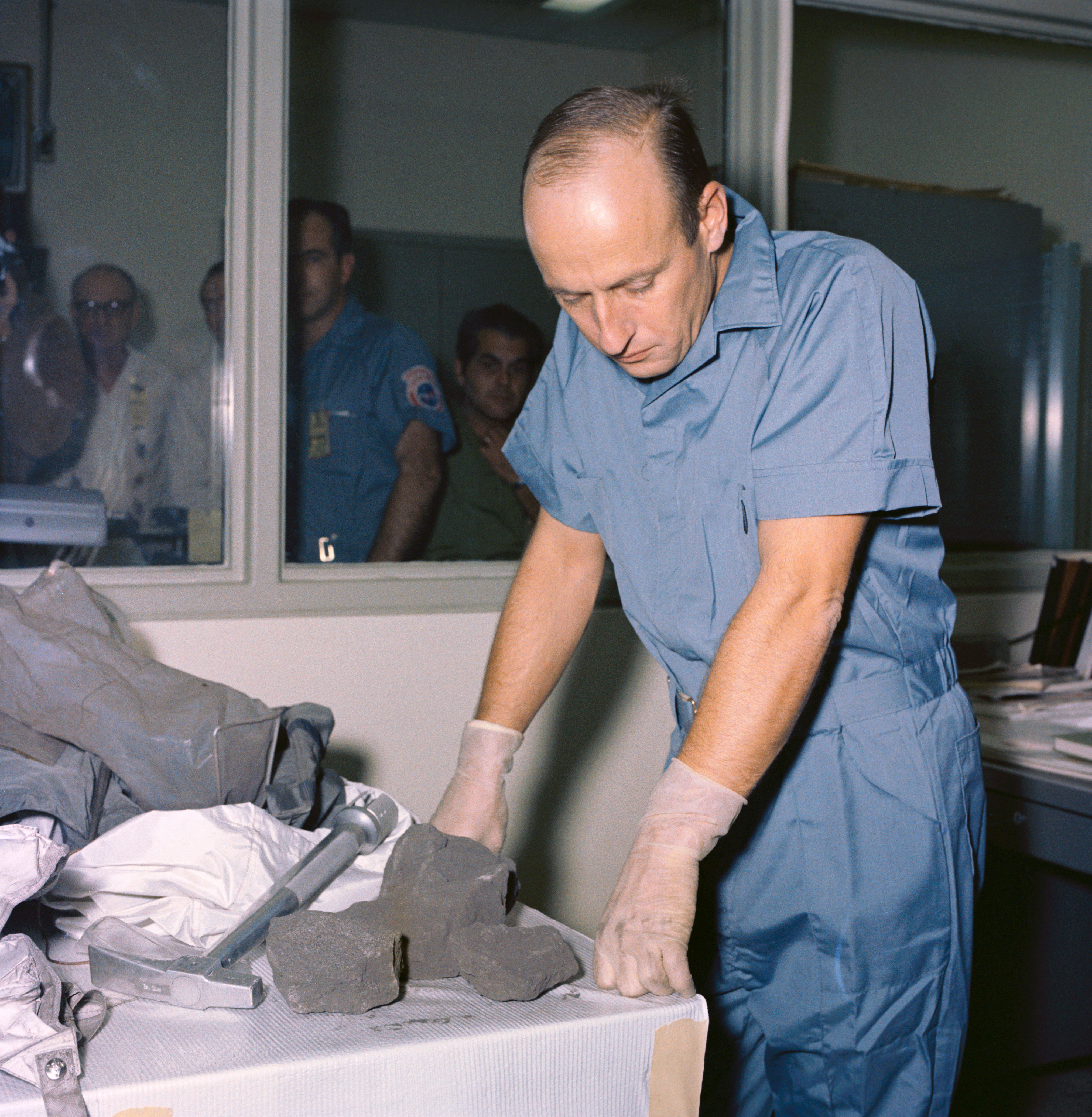 Charles “Pete” Conrad examines some of the Moon rocks he and Alan L. Bean returned from the Moon