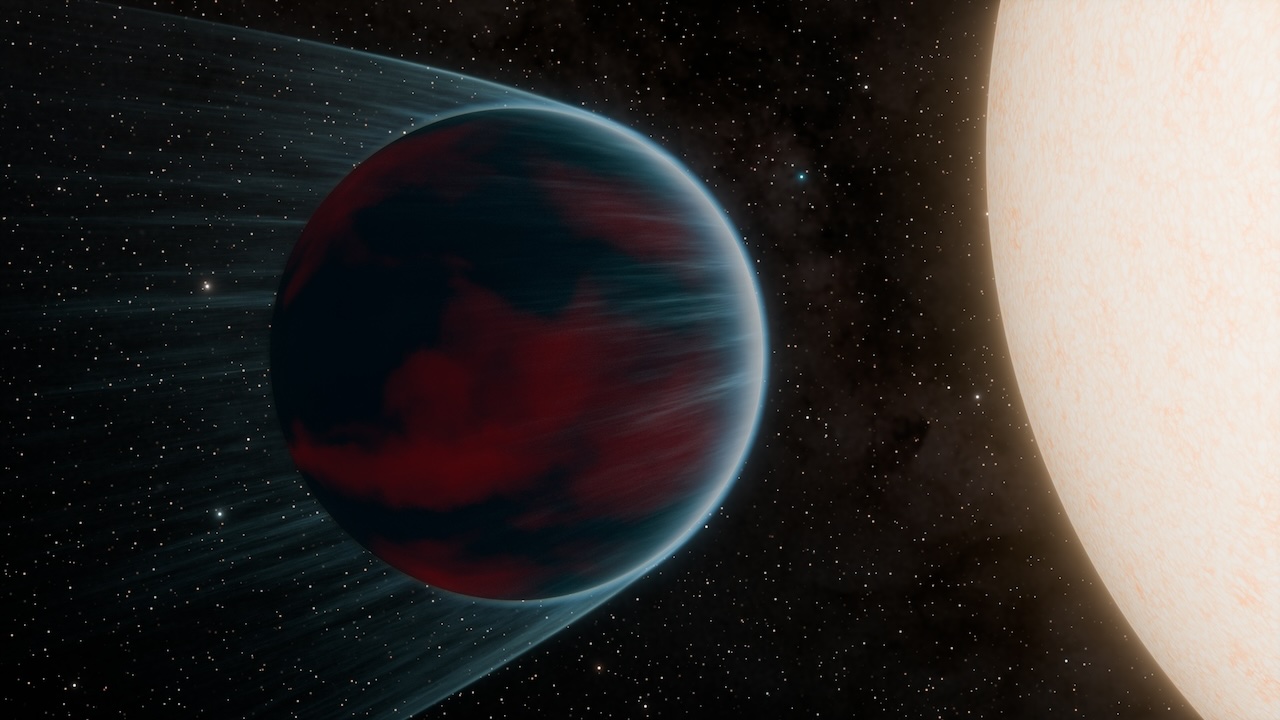 A dark planet, left, is shown in close orbit around its star, right; some of the planet's atmosphere is being blown outward by the star.