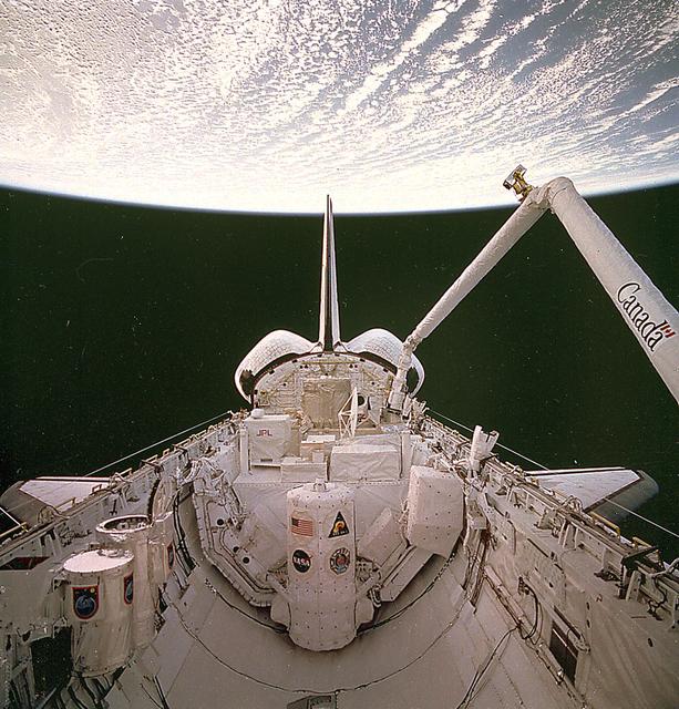 European Space Agency astronaut Jean-François Clervoy uses the shuttle’s Remote Manipulator System (RMS) to grapple the CRISTA-SPAS prior to its release