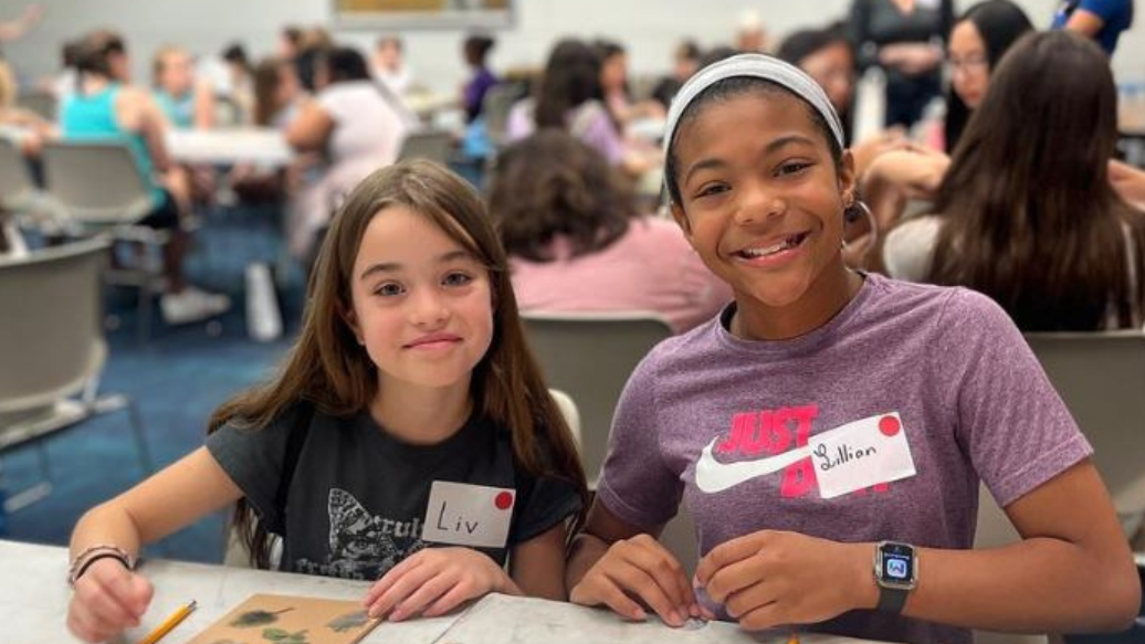 two camp-goers pause a for a photo