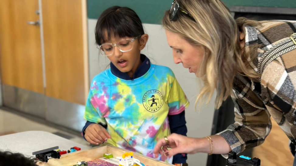 ASTRO CAMP instructor interacts with young camp-goer