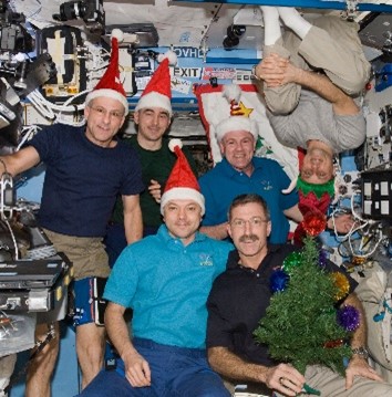 Several people in Santa hats pose for a picture