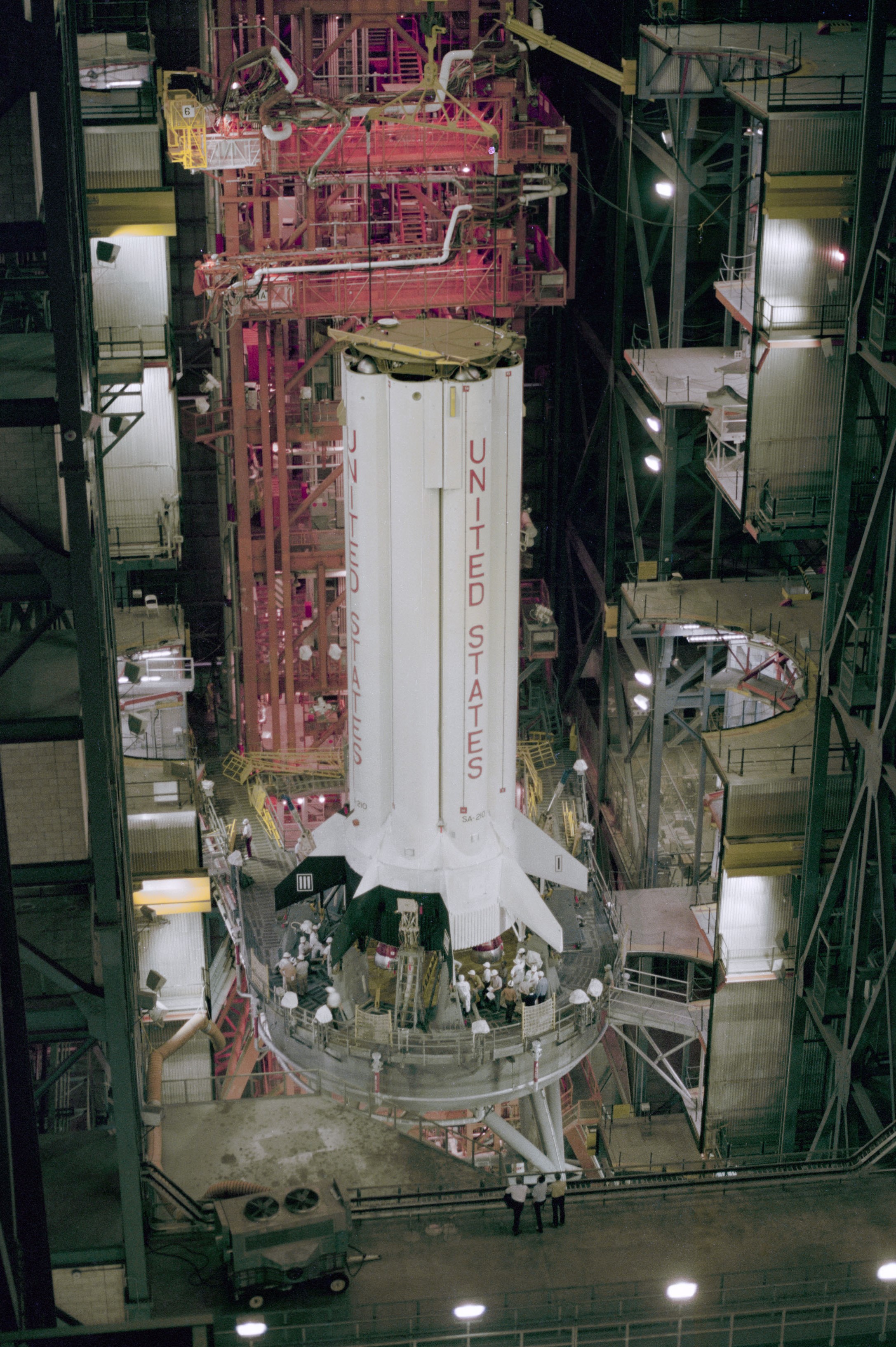 Image of a large white rocket stage inside a large assembly building